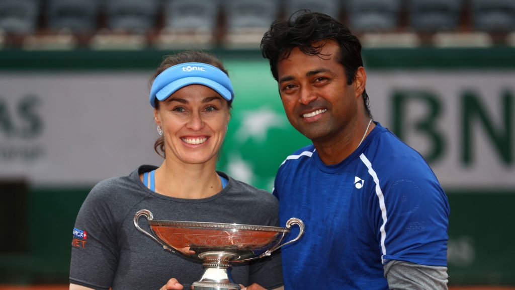 Switzerland's Martina Hingis (left) and Leander Paes hold the trophy after winning the mixed doubles final of the French Open tennis tournament against Sania Mirza and Croatia's Ivan Dodic at the Roland Garros stadium in Paris, France in 2016. 